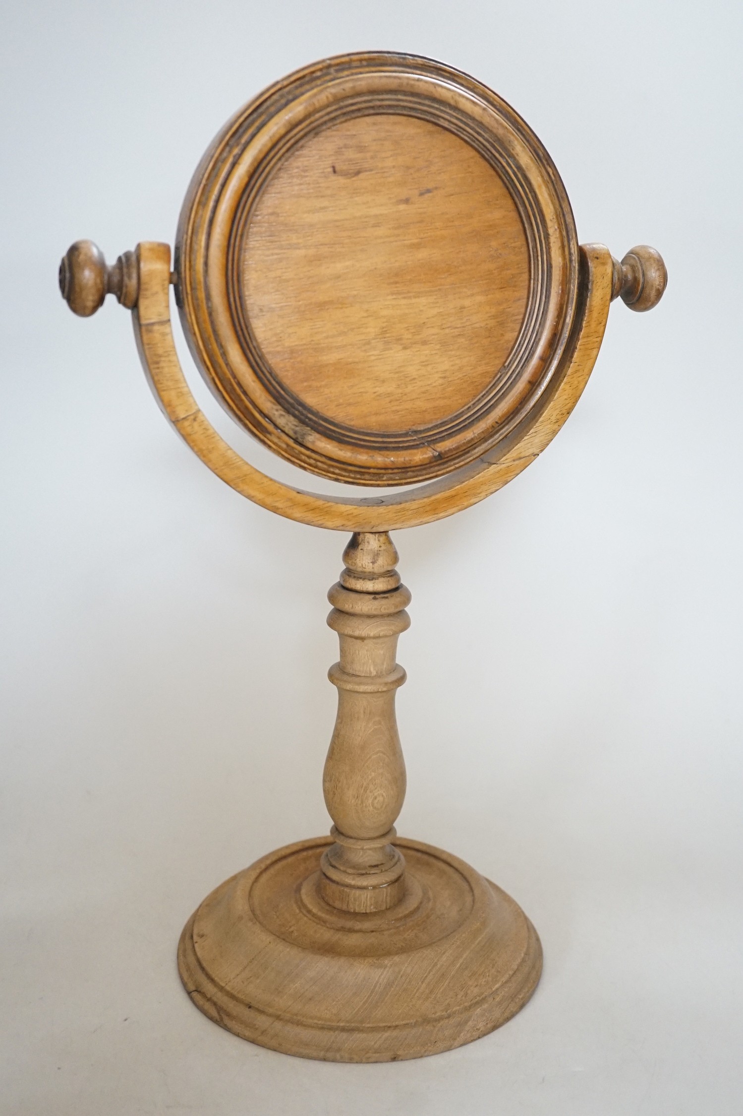 A Victorian turned wooden shaving mirror, 37cms high